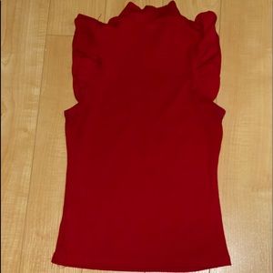 Sleeveless turtle neck red top.